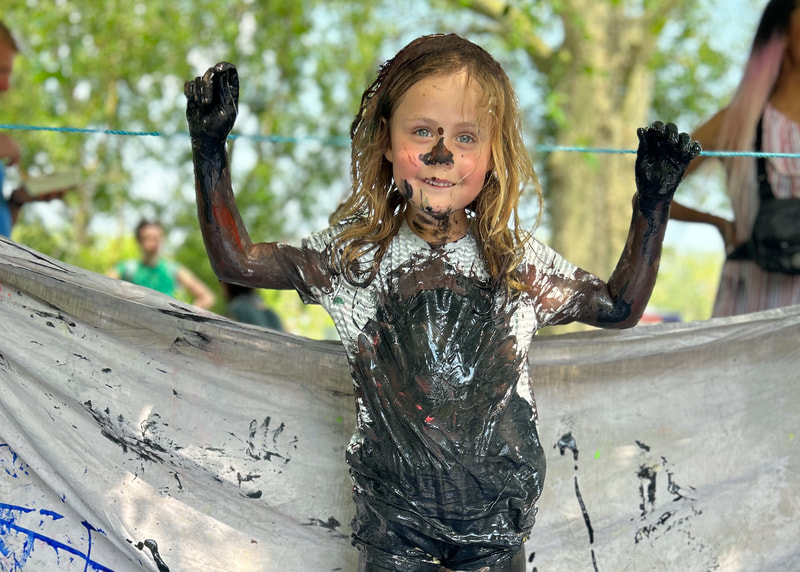 A child covered in paint