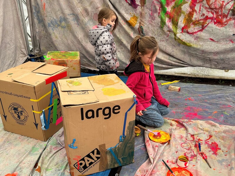 children painting cardboard boxes