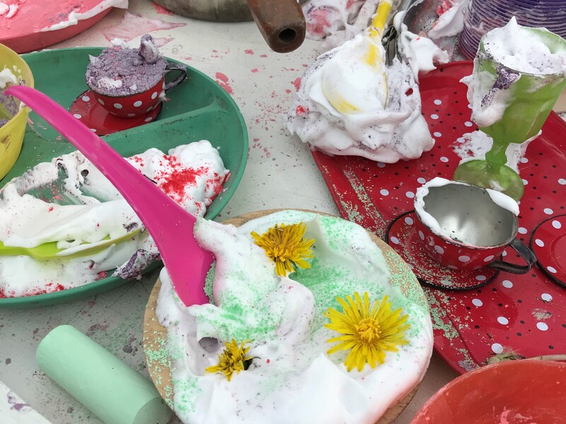 Shaving foam and flowers in cups and plates