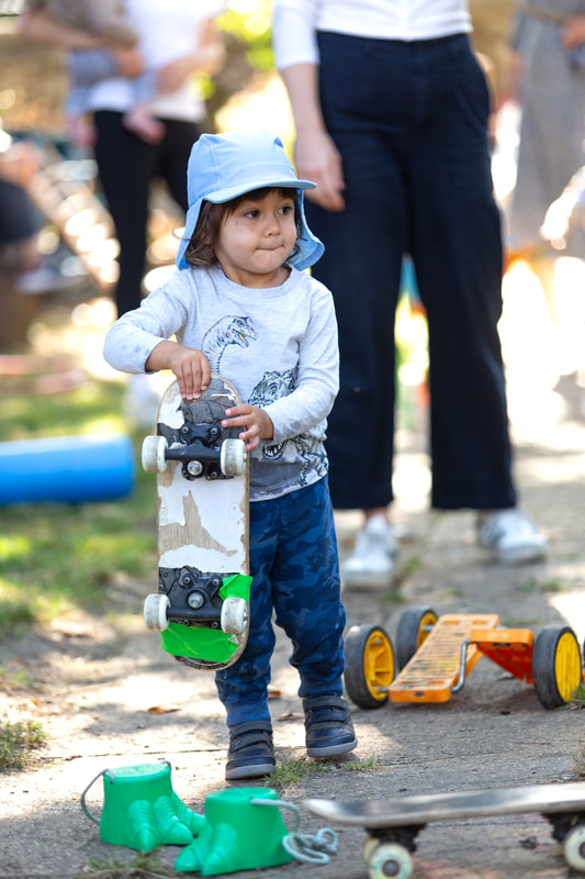 A child holding a skateboard.
